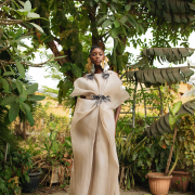 Dramatic yet elegant, flowing yet structured, this champagne Colored draped organza dress with hand beaded appliqués exudes grace and glamour.