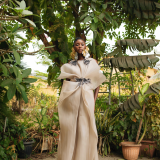 Dramatic yet elegant, flowing yet structured, this champagne Colored draped organza dress with hand beaded appliqués exudes grace and glamour.