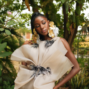 Dramatic yet elegant, flowing yet structured, this champagne Colored draped organza dress with hand beaded appliqués exudes grace and glamour.