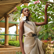 Dramatic yet elegant, flowing yet structured, this champagne Colored draped organza dress with hand beaded appliqués exudes grace and glamour.