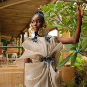 Dramatic yet elegant, flowing yet structured, this champagne Colored draped organza dress with hand beaded appliqués exudes grace and glamour.