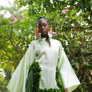 The perfect blend of structure and fluidity, this green ombré dress with pleats down and floral appliqués is the perfect statement piece.